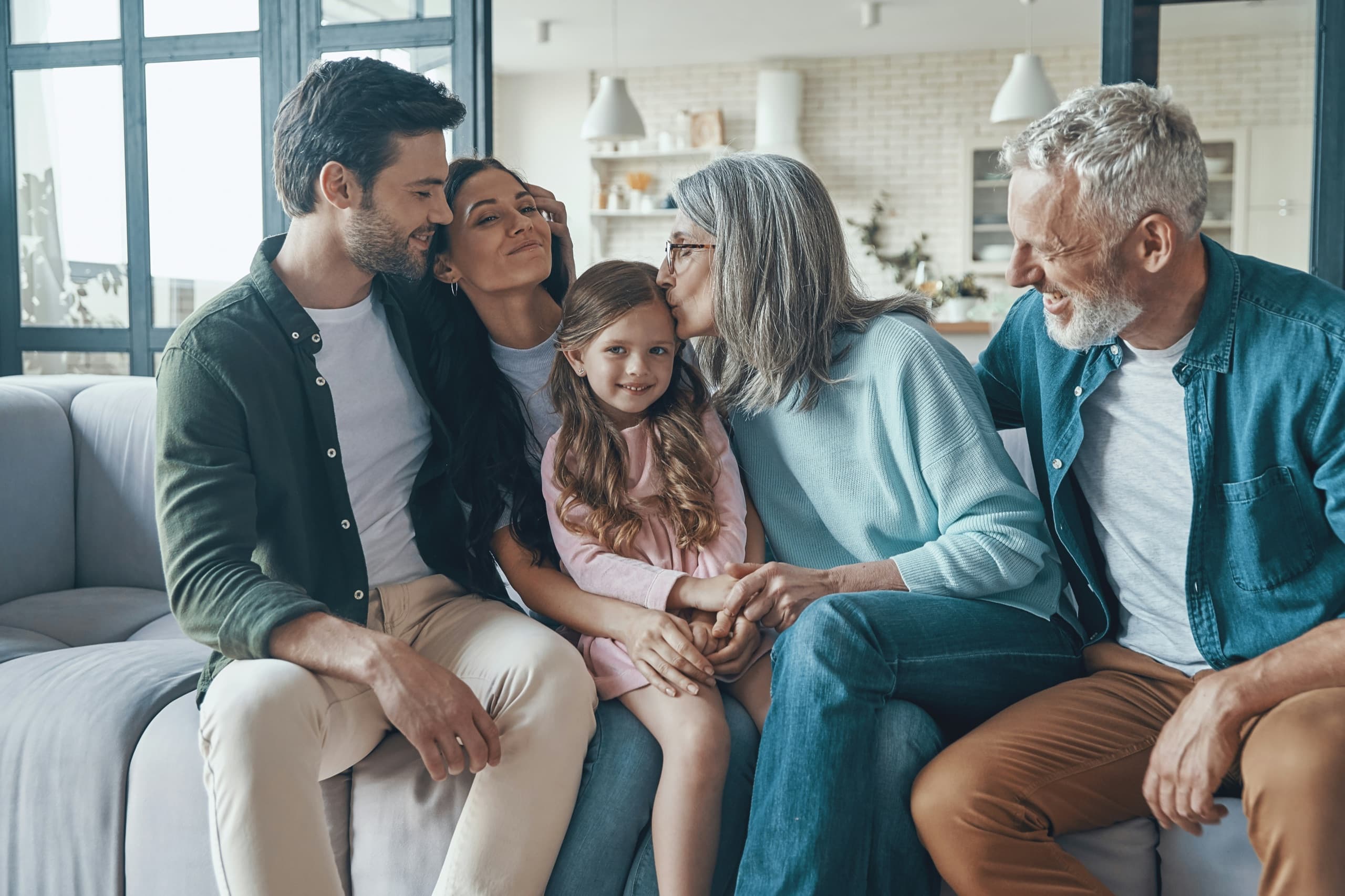 An intergenerational family at home in warm, natural light